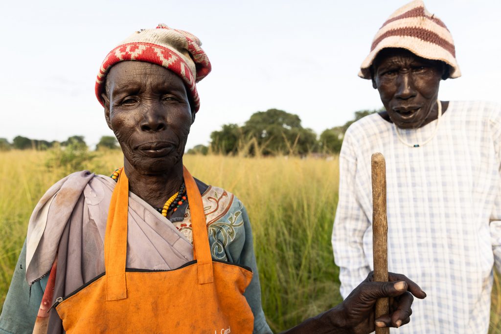 Two internally displaced people standing in the marsh in Ayod, South Sudan.